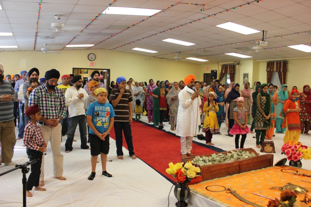 Sangat standing for Ardas at Gurdwara Akaljot