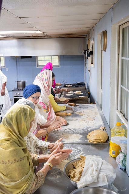 Women of the Sangat making roti together for langar
