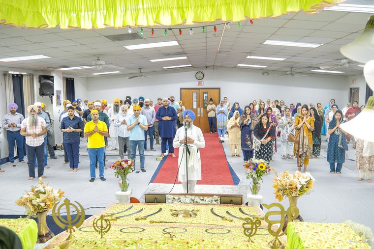 The Sangat standing together for Ardas in Darbar Sahib at Gurdwara Akaljot
