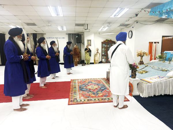 The Sangat washing the Nishan Sahib pole with milk and water, Garland TX