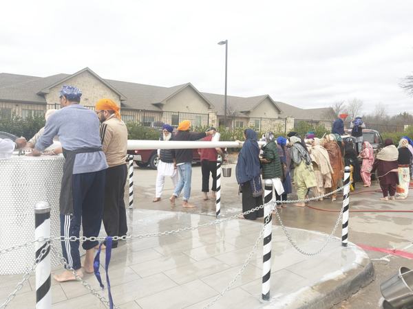 Sevadars lowering the Nishan Sahib for its yearly chola change, Garland TX