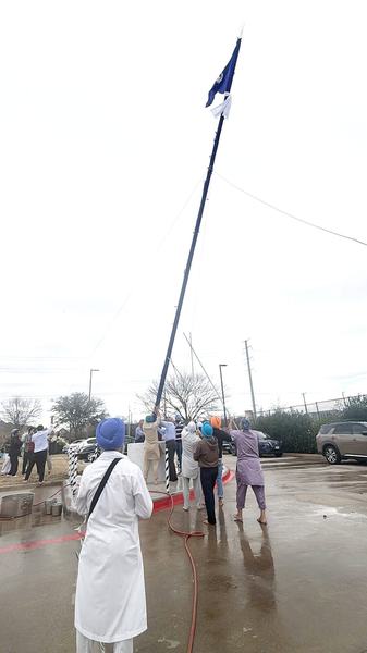 The Nishan Sahib standing against the sky after the sewa, Garland, Texas